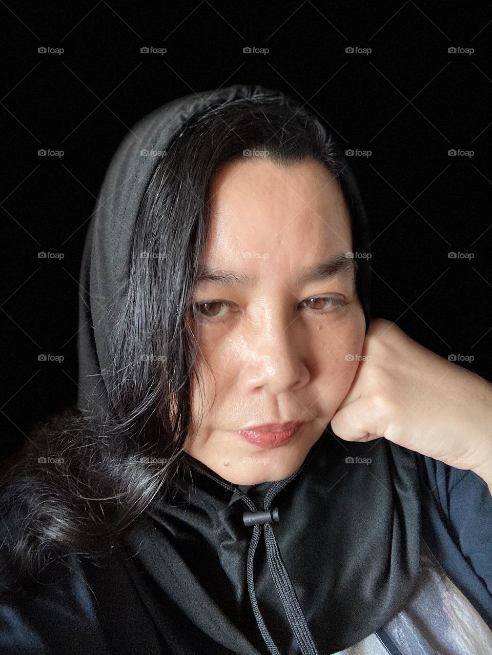 Portrait, female in a black hood 