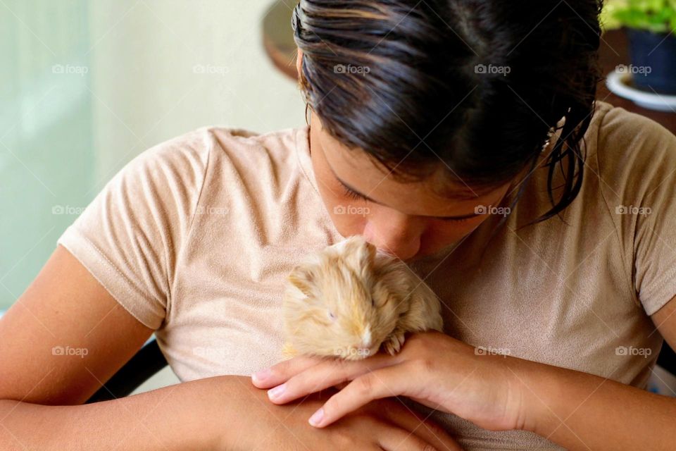 Girl petting a guinea pig