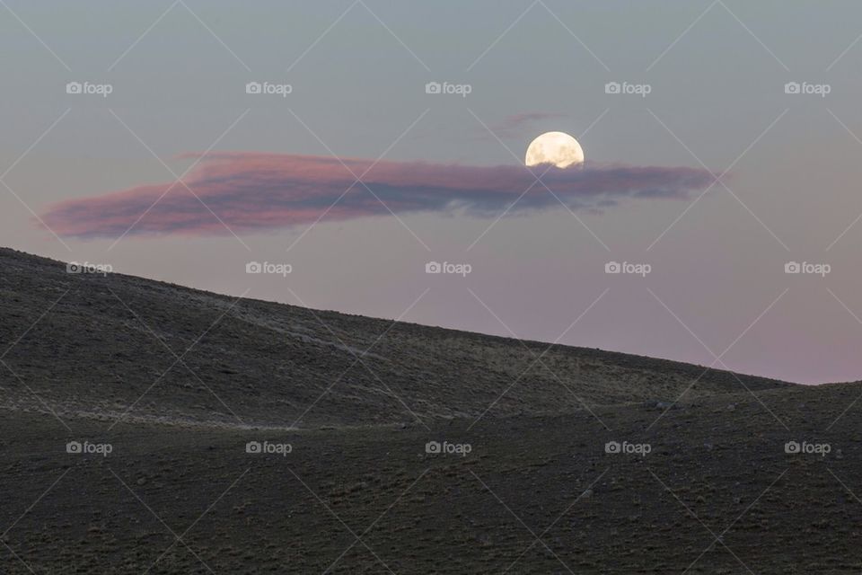 Patagonian landscape at sunset with bright moon and cloud