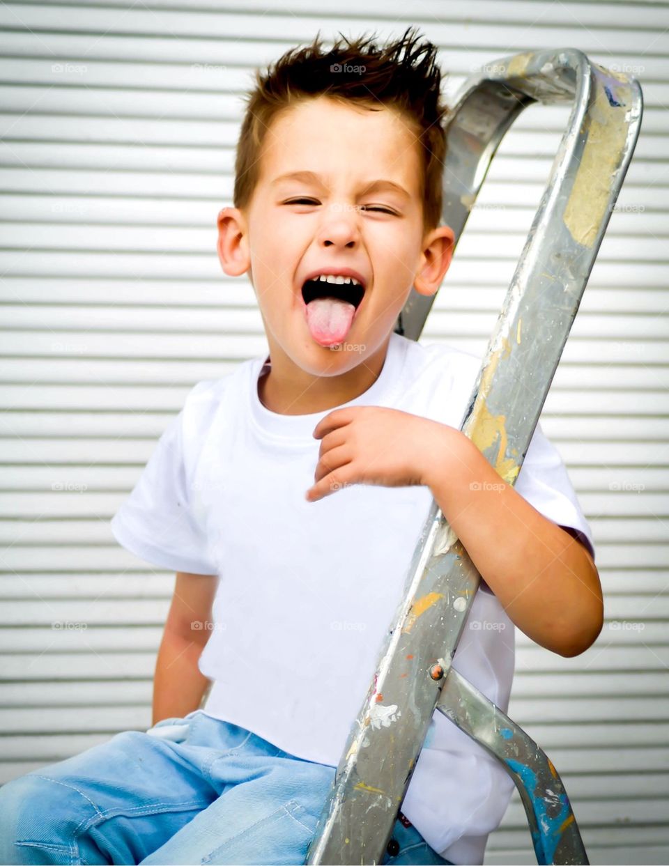 Boy sticking tongue out cheering Playing 