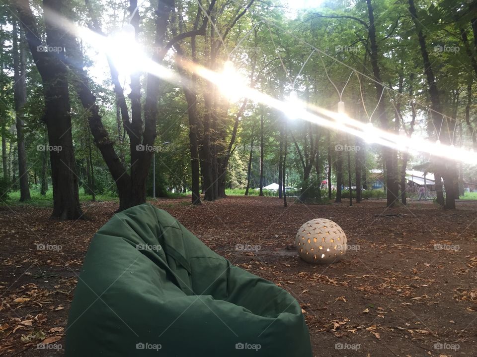 Evening at the park with lanterns and a sack chair