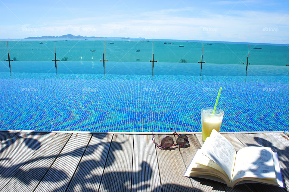 relax with cocktail at swimming pool and sea view