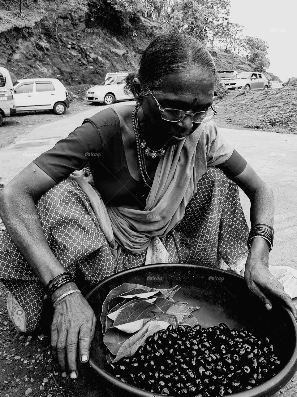 A lady with her fruit basket, roadside seller, black and white click, honestly earning and living her life. Proud moments, no regrets, self employed,.. Lonely and lonely....