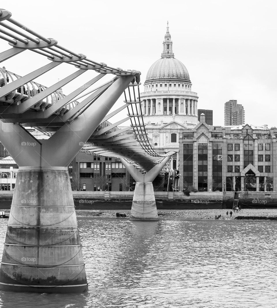 A view along the Millennium Bridge from underneath looking over the Thames to Millennium Bridge House & St Paul’s Cathedral 