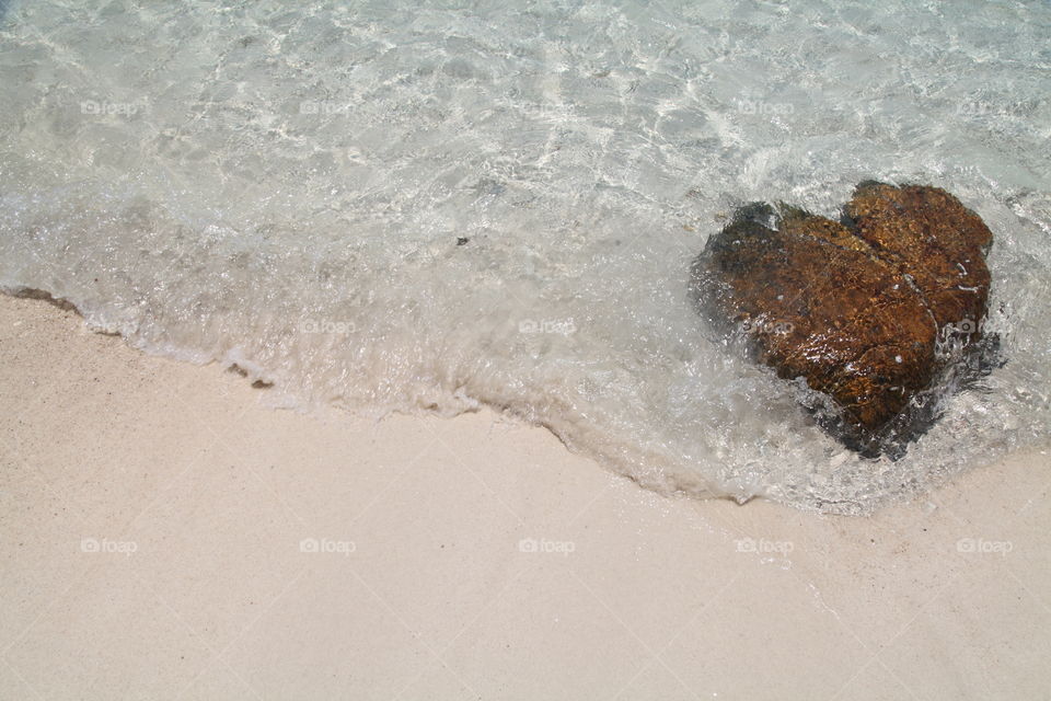 heart shaped stone wave on the beautiful white sand beach summer Thailand