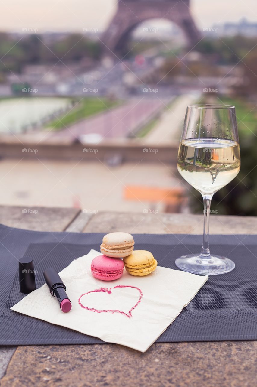 Wine glasses with croissant on the Eiffel Tower background 