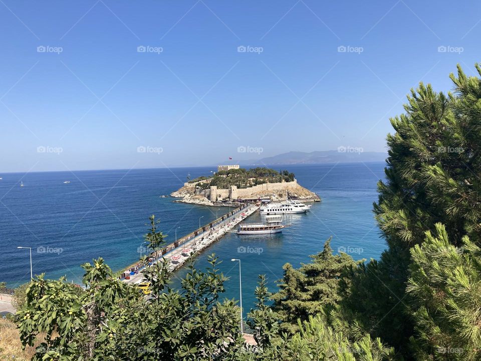 Beach time on holidays. Blue sky and tall palm trees. Sunsets and sunny days. Summertime in Kusadasi. Vacation travel in Turkey . Summer view. Sunny day during vacation 