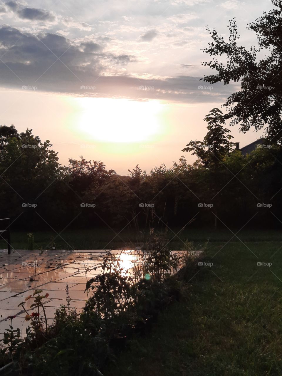 summer sunrise with front clouds and reflection  in stone terrace