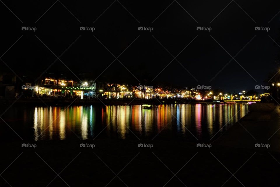 Night cityscape with the bright lights reflecting in the water 