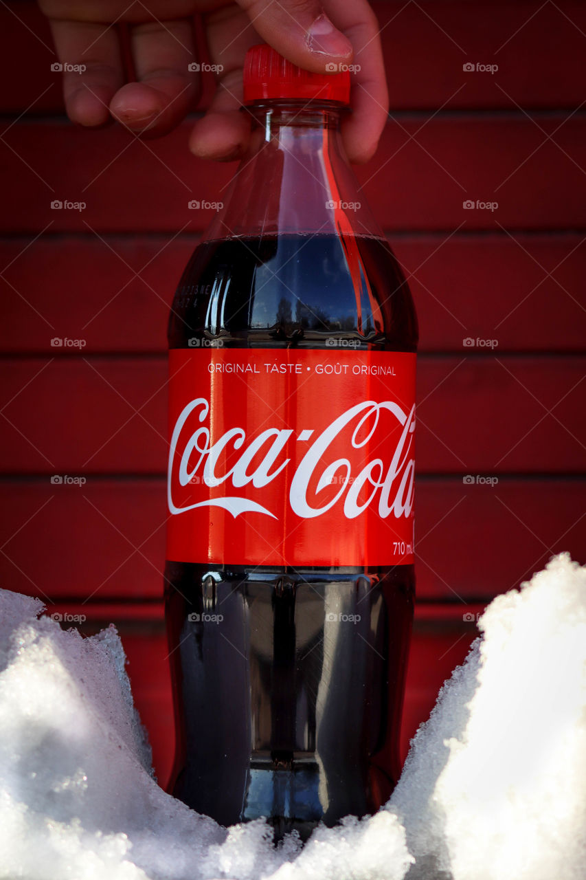 Bottle of a Coca-Cola on a red background