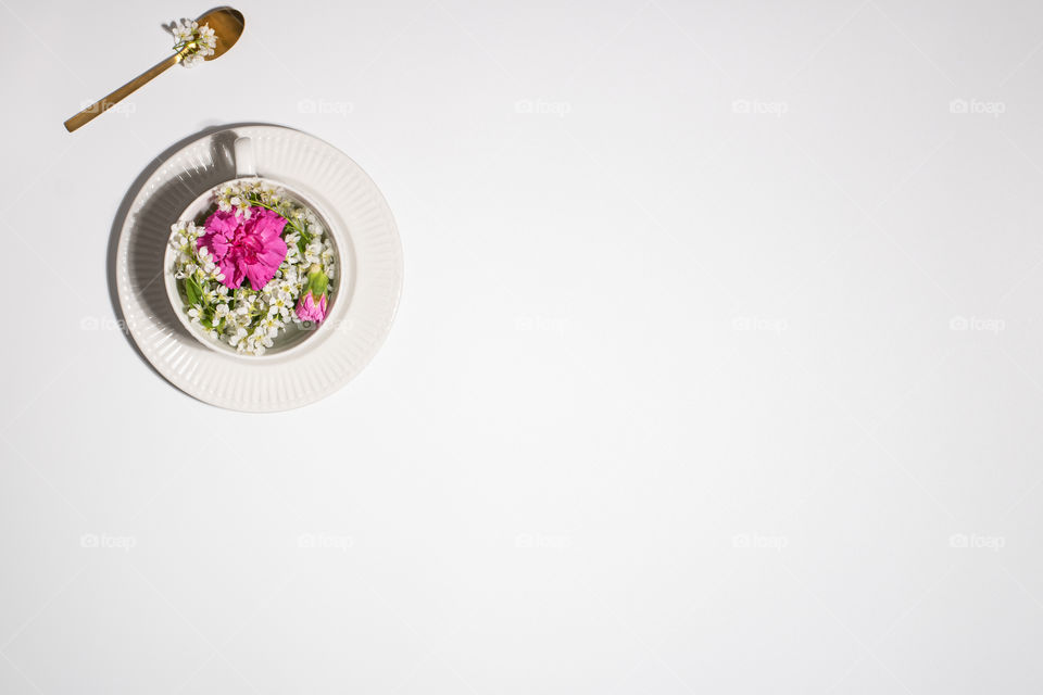 Herbal tea, flowers in a cup, white background 