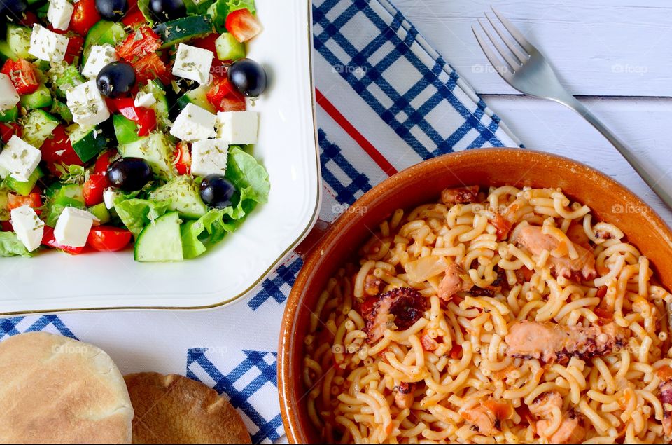Greek salad and octopus with pasta