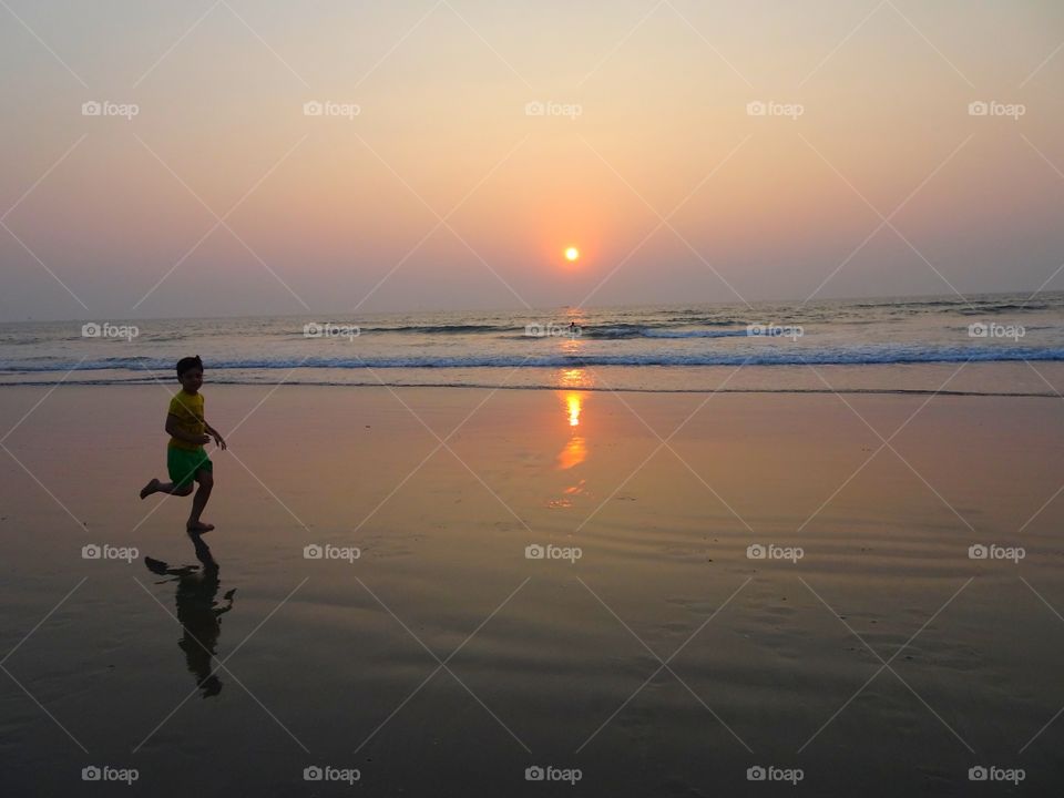 having fun running on the beach.