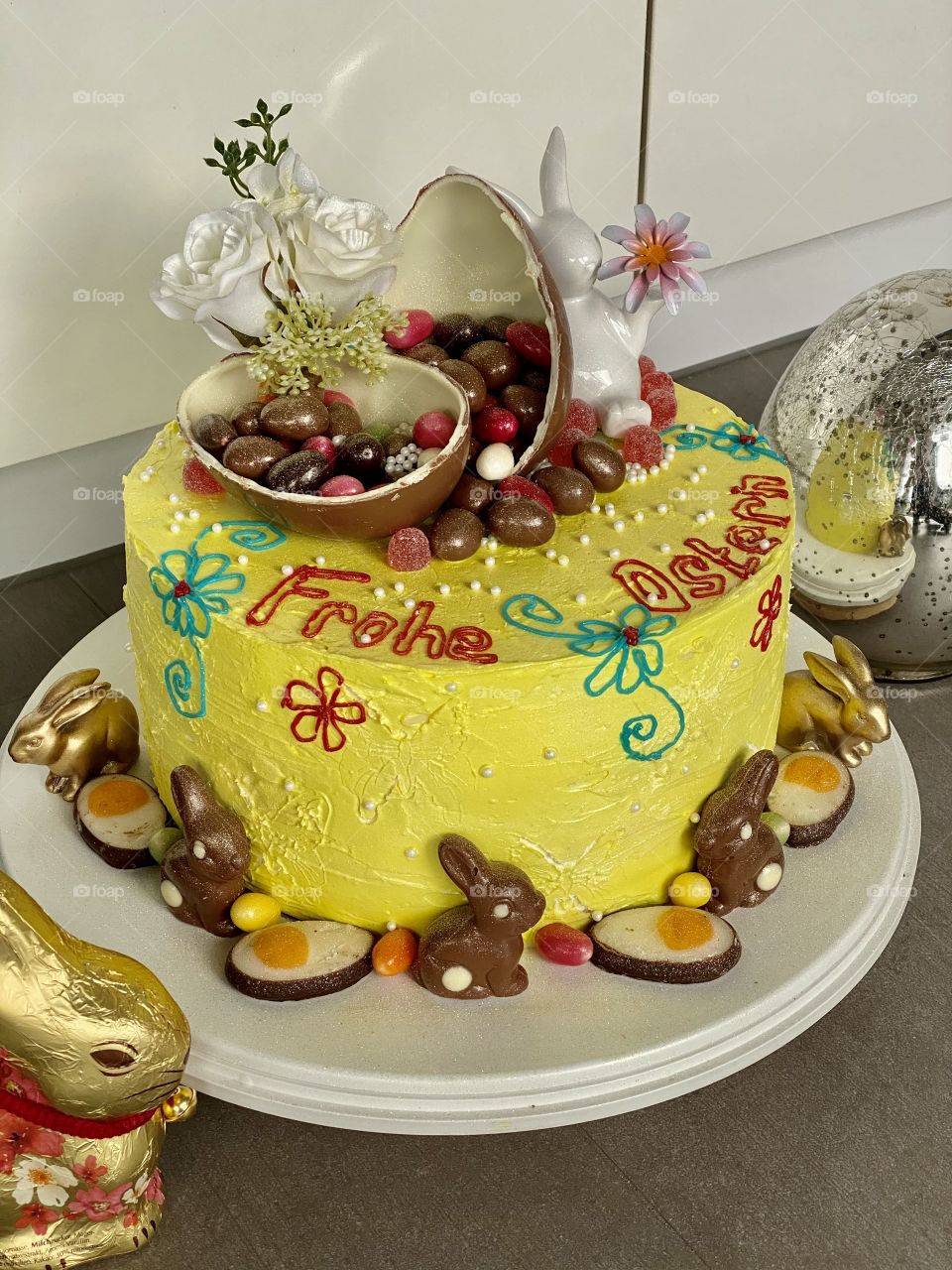 yellow Easter cake, birthday cake, bunny cake, chocolate bunnies, chocolate eggs, colored eggs, Easter eggs, colorful eggs, flowers on the cake, good Easter, raspberry cream cake