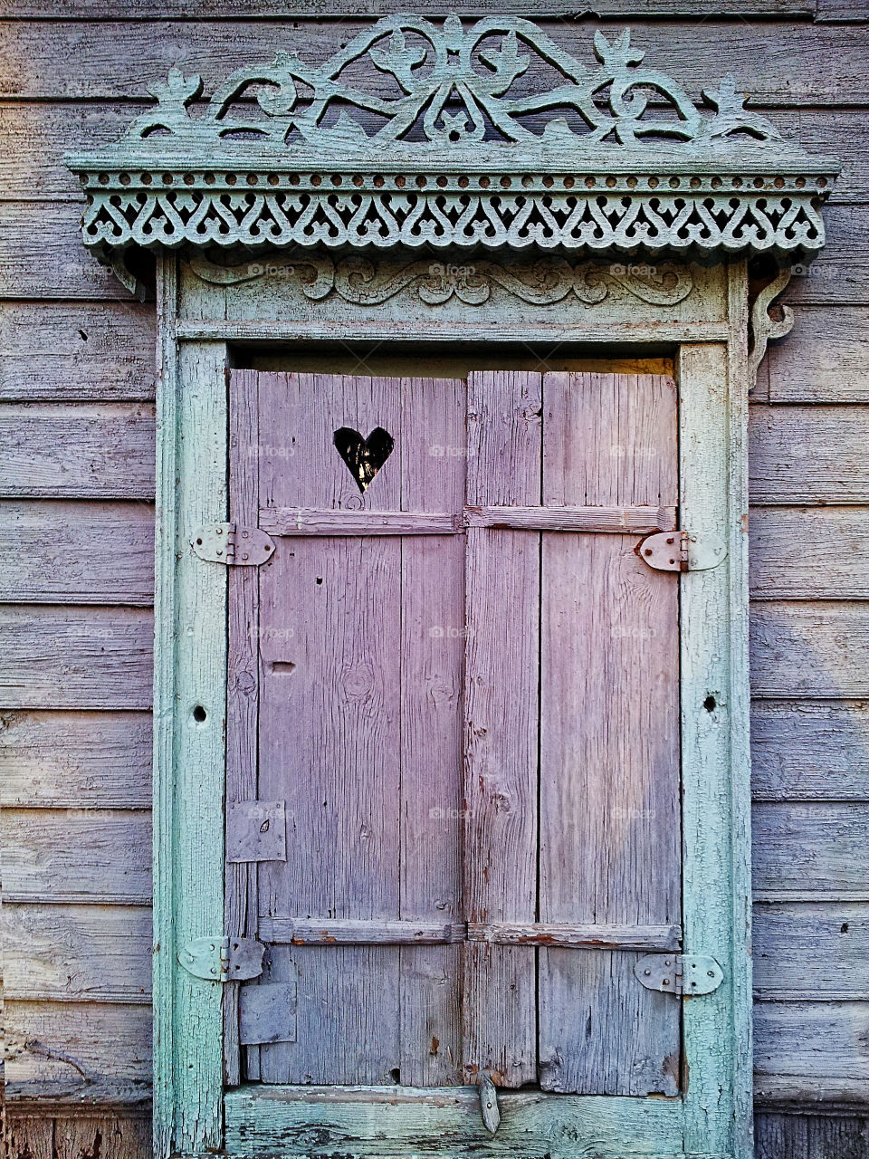 the village window with heart pattern