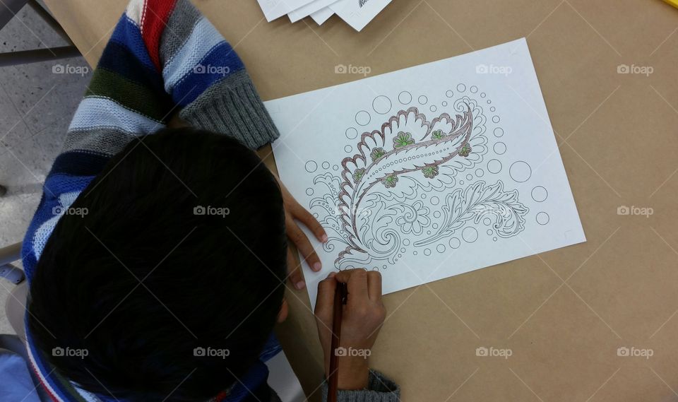 Kid coloring a pattern