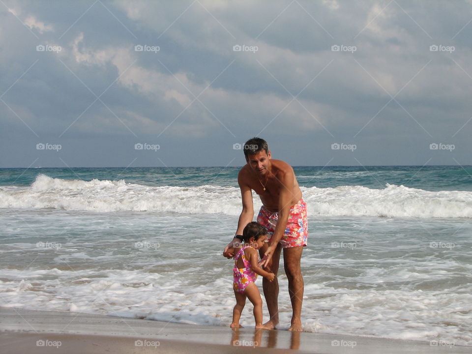 Father with his daughter at beach 