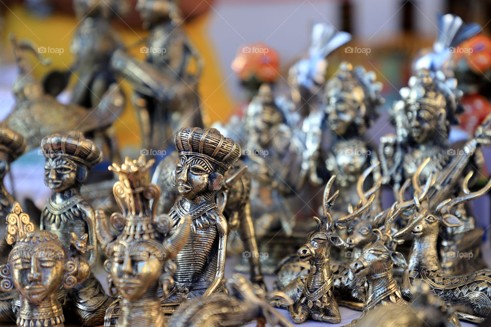 Indian handicrafts metal idols of Indian gods at the Hunar Haat, New Delhi, India