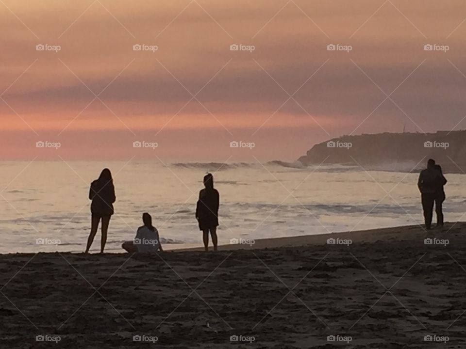 Silhouette of beachgoer at sunset