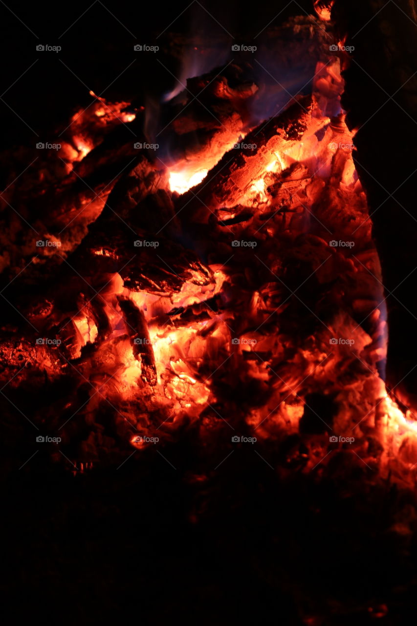 Burning coals from a bonfire late into the night.