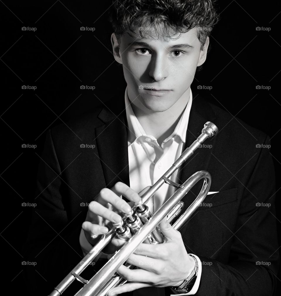 Studio portrait, study in black-and-white, handsome young man, Jazz heritage trumpeter