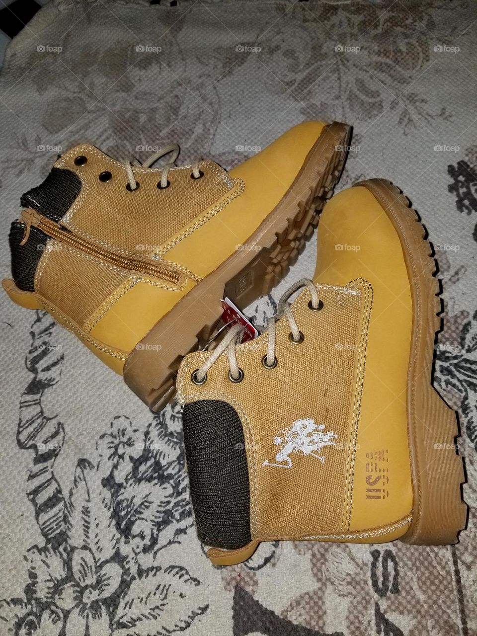 USPA polo boots. Mixture of materials( canvas) well designed with a cute white logo. Bottom is tough rubber texture print.