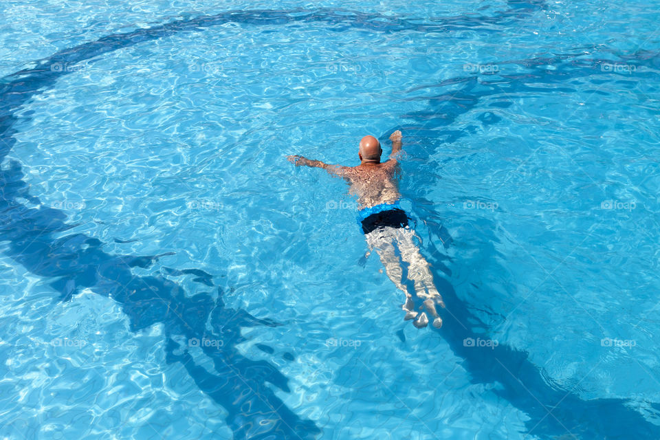 Senior man swimming in the pool