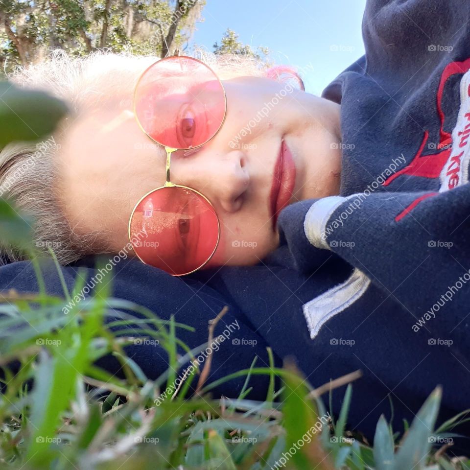 A selfie I took while laying in the grass and resting at Lake Lily Park after a stressful day.