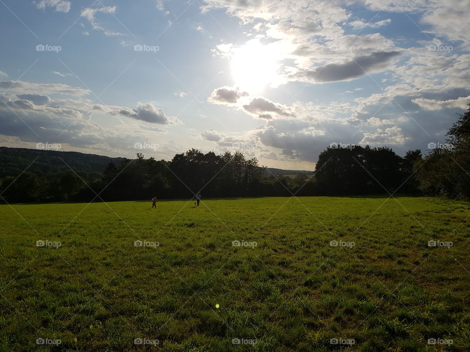 nature walk the sun shines between the clouds