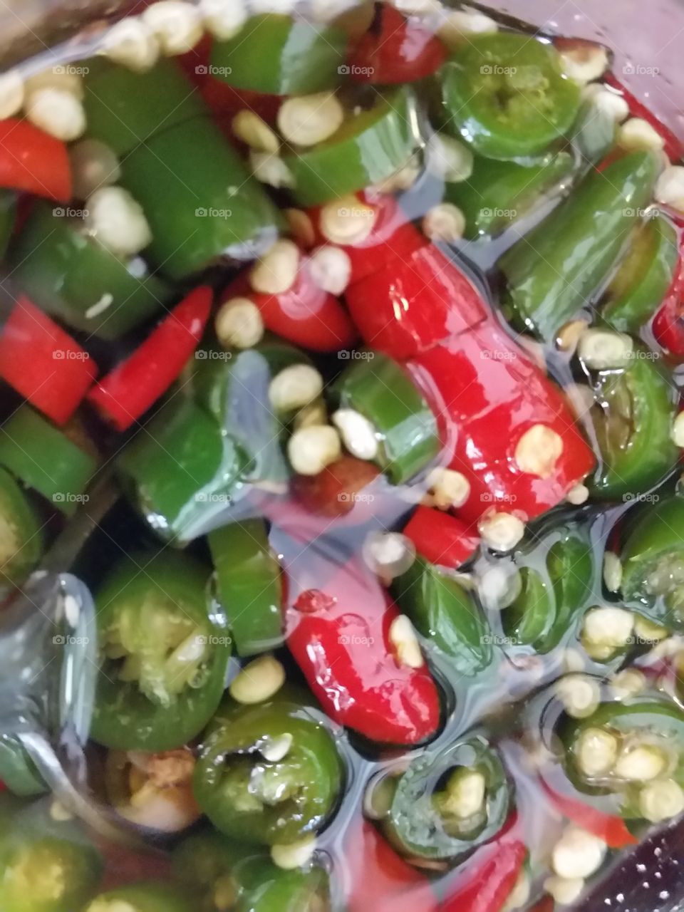 Chilly Sauce. Spicy Green and Red chillies pickled in vinegar.