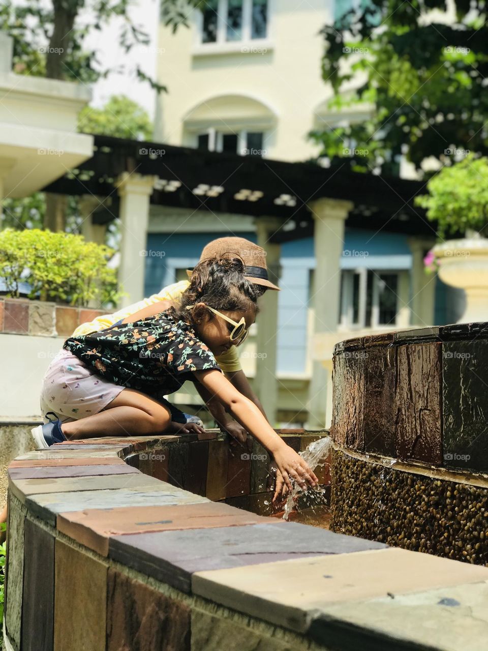 Kid’s are playing at fountain with running water and they enjoying summer.