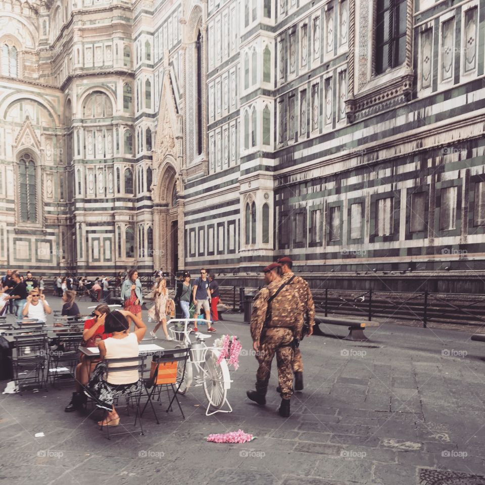 Military in front of the Duomo. A great contrast to the joy of bright pink flowers on the bike.