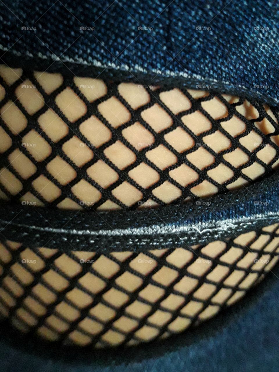 jeans with fishnet stockings underneath