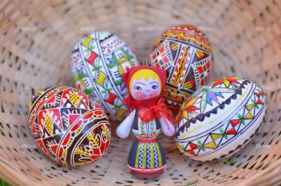 Happy Easter with painted eggs and traditional doll