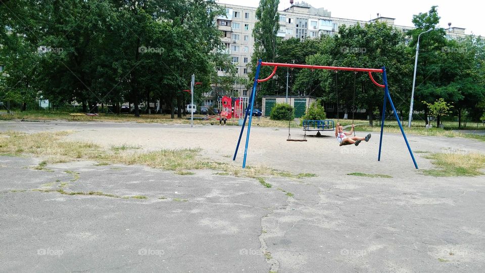 child riding on a swing