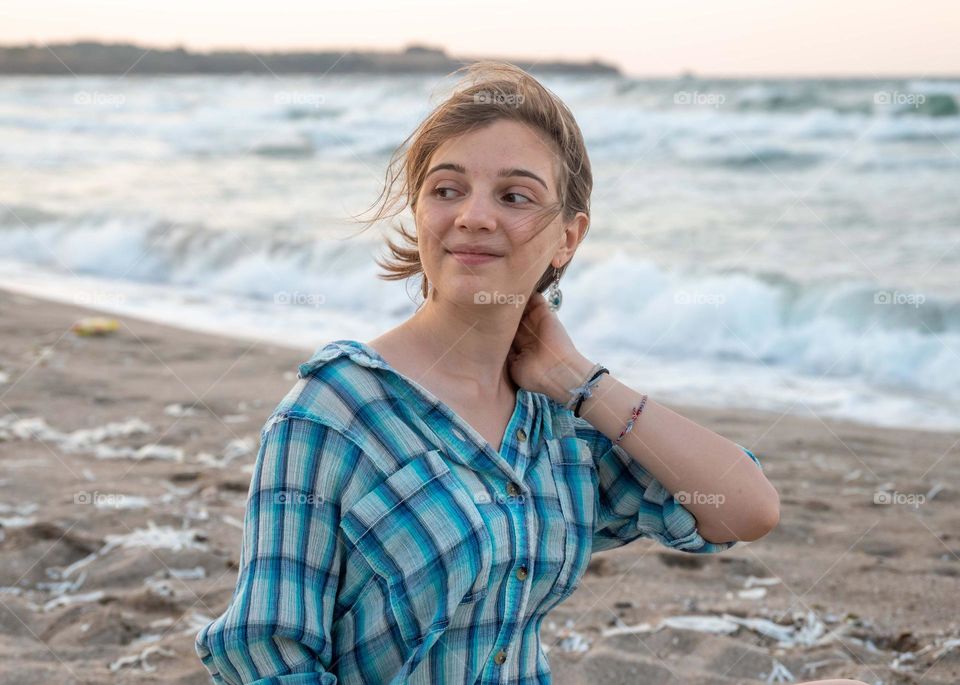 Energetic, Light-Hearted, and Vibrant Portrait of Blonde girl, on sea background