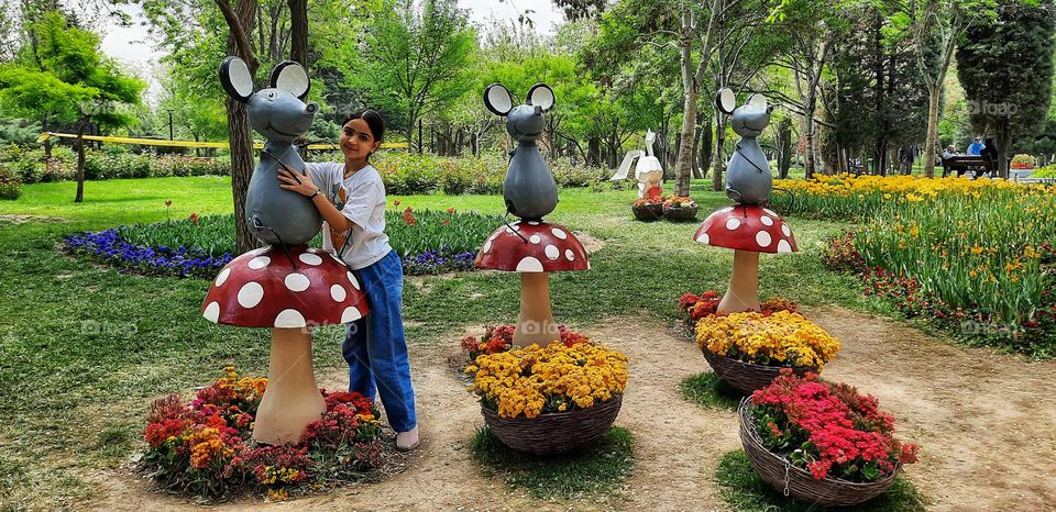 Teenage girl welcomes spring. Rebirth season is a lovely reminder to show how beautiful everything can be. She laughs happily in the spring arms, maybe forgets her illness for a moment .