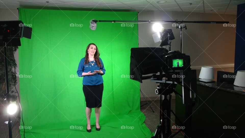 Female standing in front of green screen