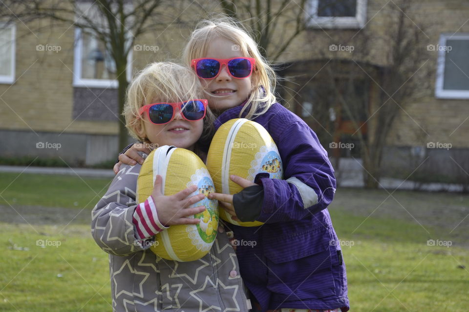 Teo young sisters is hugging after they found their easter eggs with candy in Malmö Sweden.