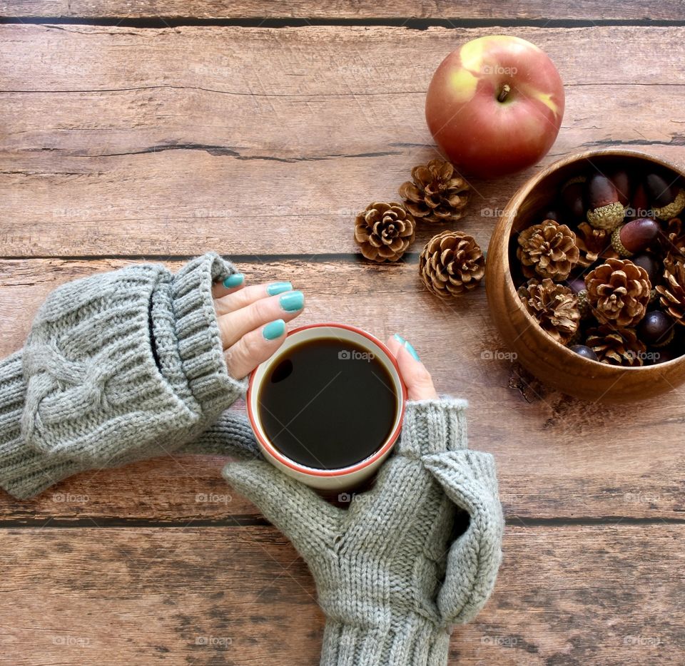 Circles, autumn, hot cup of tea and an apple and a bowl of pine cones and acorns