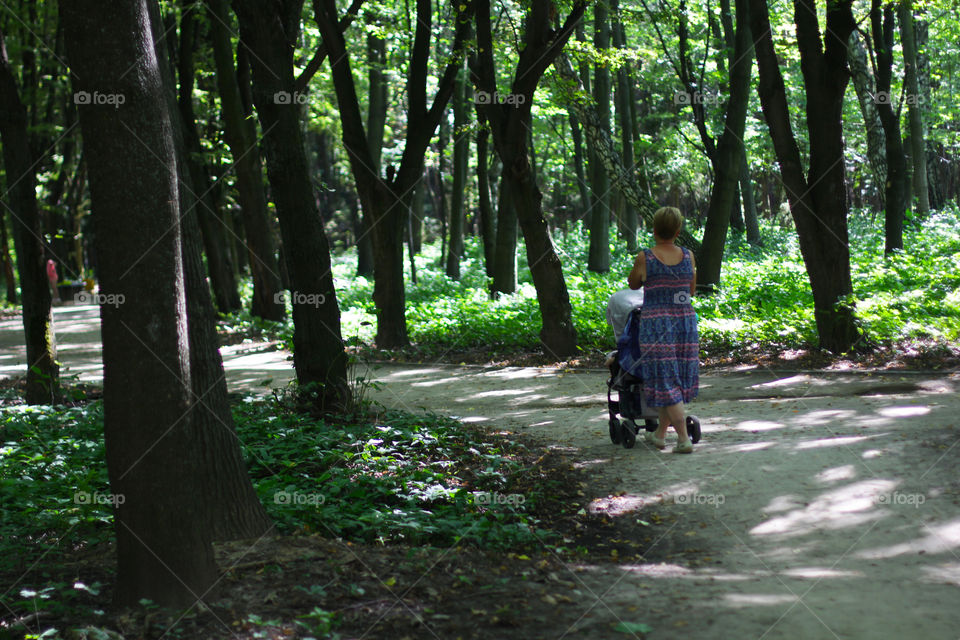 Woman with a stroller in the park