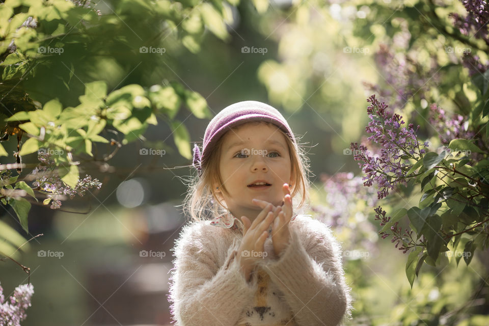 Cute Little girl in a blossom park