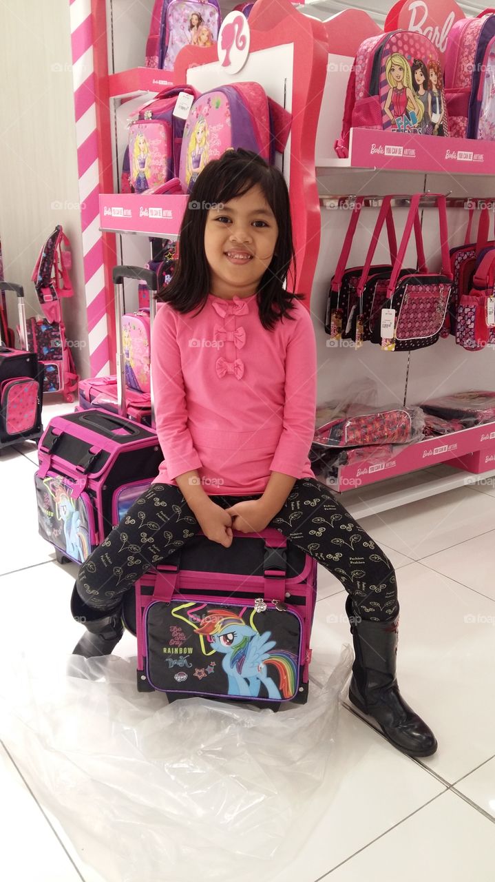 at sm mall my granddaughter sitting on pony bag behind her are barbie bags