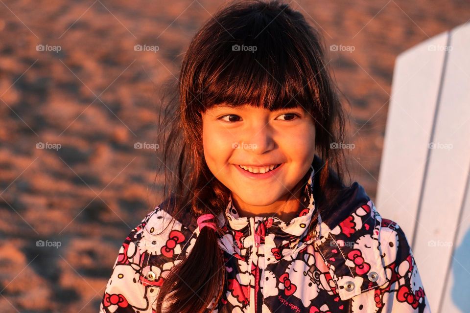 Cute smily girl on an empty beach