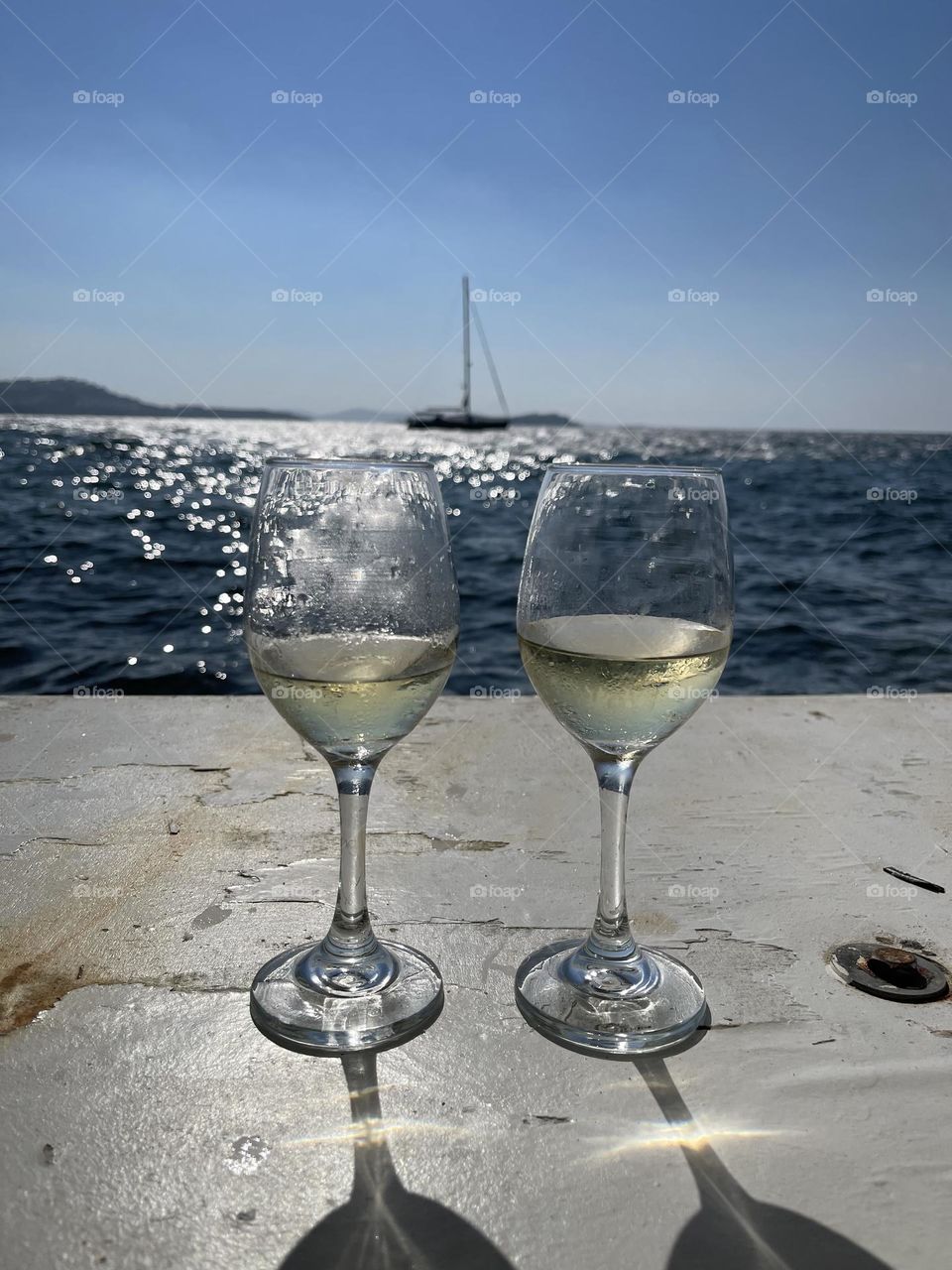Wine glasses and the Aegean Sea.