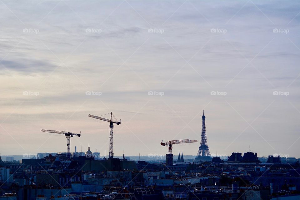 Eiffel Tower and cranes in Paris 