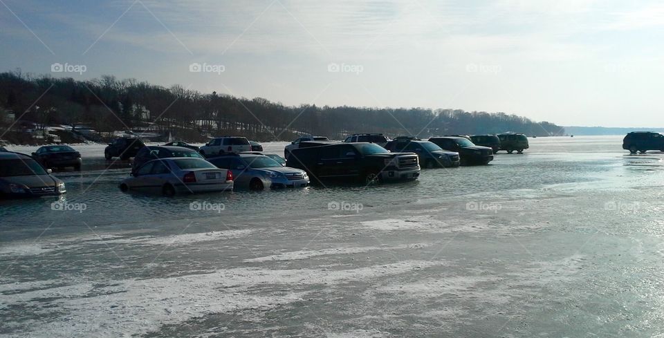 Agony in Slow Motion 2: Cars parked on Lake Geneva, WI for Winterfest slowly sank into the water as temperatures rapidly rose by the afternoon.