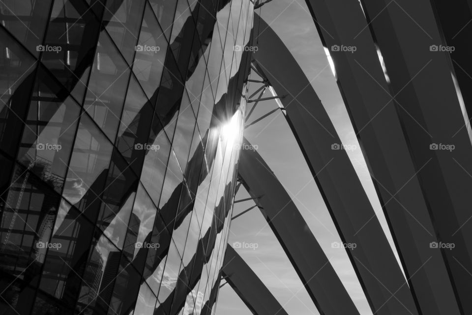 Superstructure of curtain glass and huge pillars with shadows forming nice shape