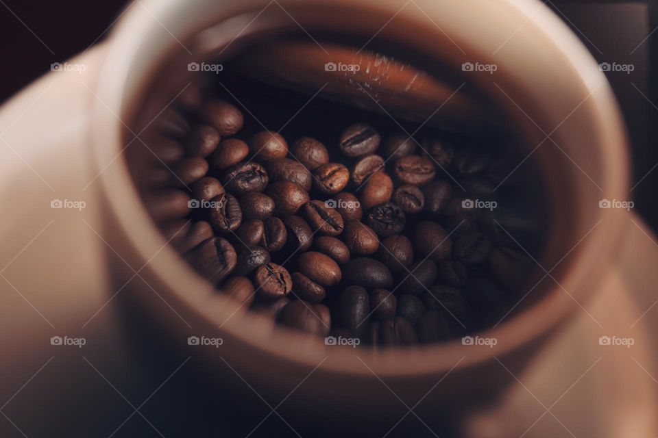 Reflection of the roasted coffee beans in cup