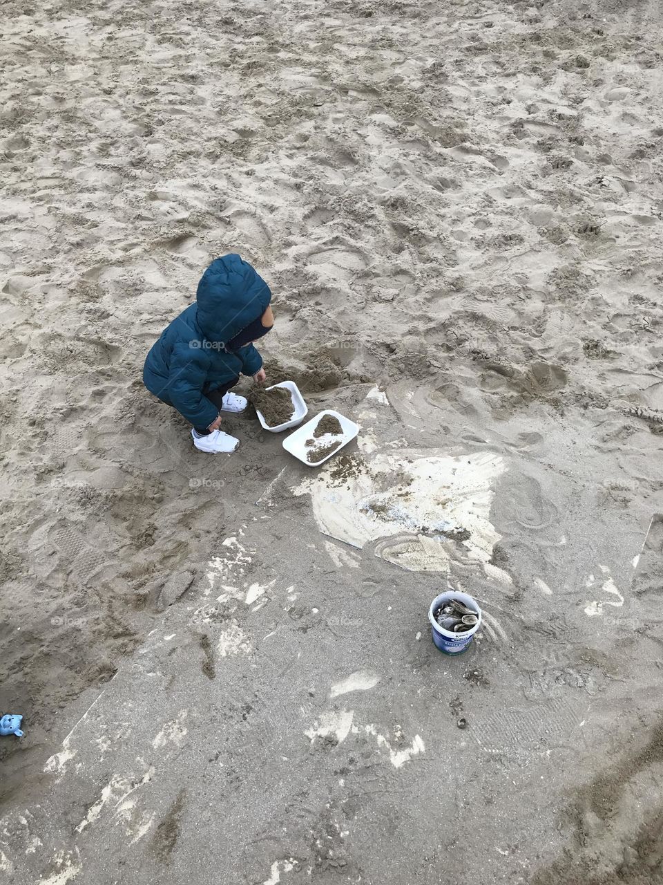 children play in the sand on the beach in winter